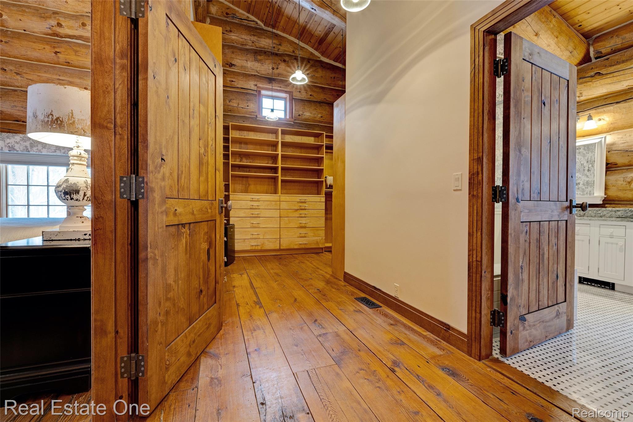 4340 Lahring Road Holly, MI 48442 - Photo 26 of 89 Corridor with rustic walls, vaulted ceiling, light wood-style flooring, and wooden ceiling