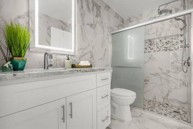a bathroom with a sink toilet and shower