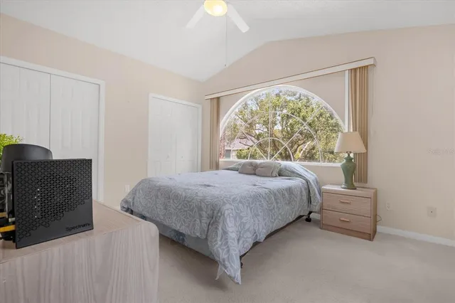 a bed sitting in a bedroom next to a window