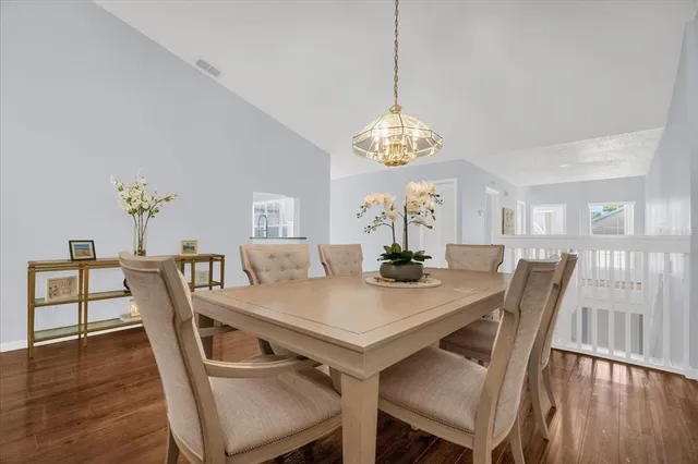 a view of a dining room with furniture wooden floor and chandelier