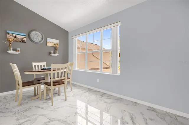 a dining room with wooden floor and a window