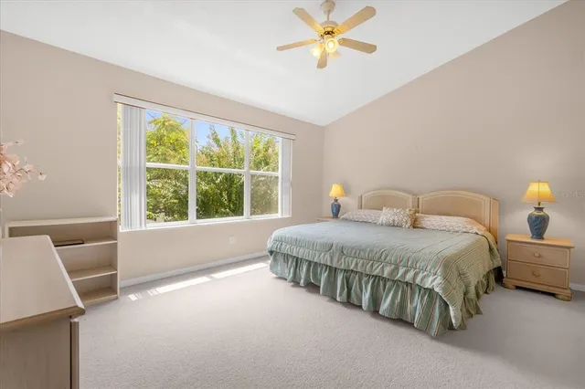 a spacious bedroom with a bed and a window