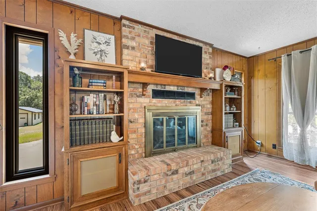 a living room with fireplace furniture and a flat screen tv