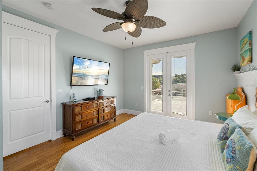 204 66th Street Holmes Beach, FL 34217 - Photo 18 of 53 a bedroom with a bed and a chandelier fan
