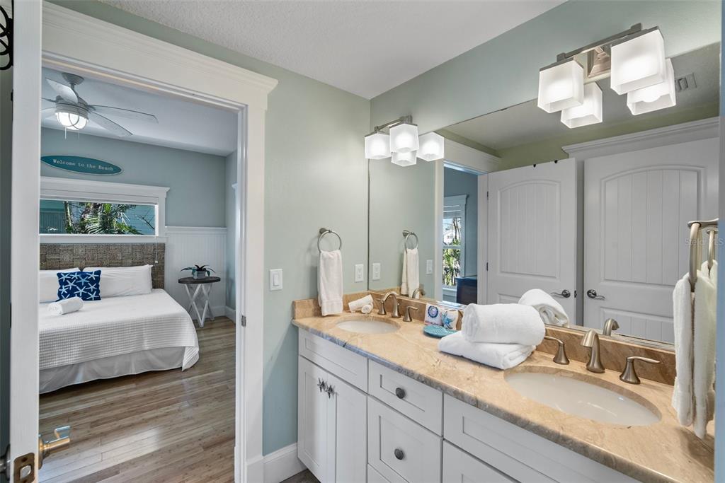 204 66th Street Holmes Beach, FL 34217 - Photo 21 of 53 a en suite bathroom with double sink and a mirror