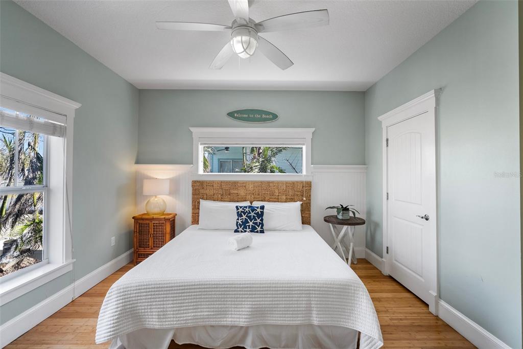 204 66th Street Holmes Beach, FL 34217 - Photo 22 of 53 a bedroom with a bed and wooden floor