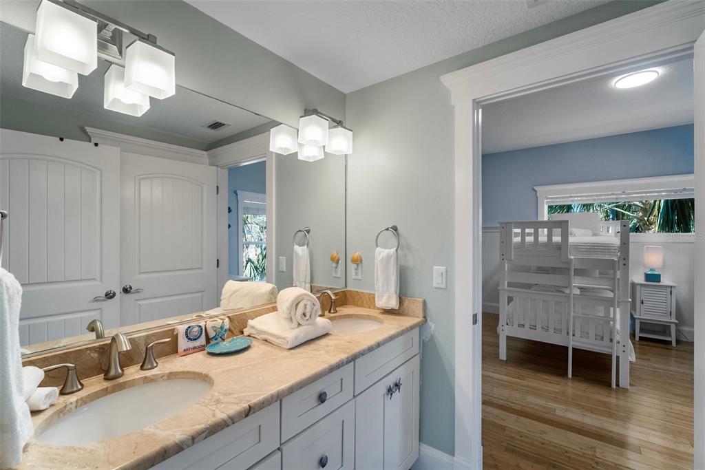 204 66th Street Holmes Beach, FL 34217 - Photo 24 of 53 a bathroom with a double vanity sink mirror and shower