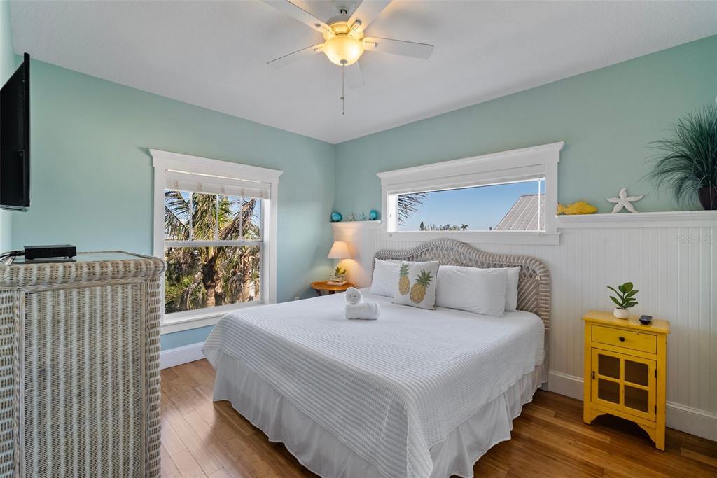 204 66th Street Holmes Beach, FL 34217 - Photo 28 of 53 a bedroom with a bed and a chandelier
