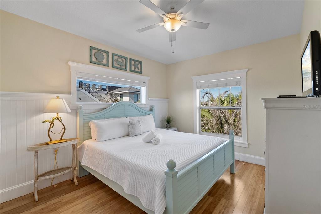 204 66th Street Holmes Beach, FL 34217 - Photo 30 of 53 a bedroom with a bed and a chandelier