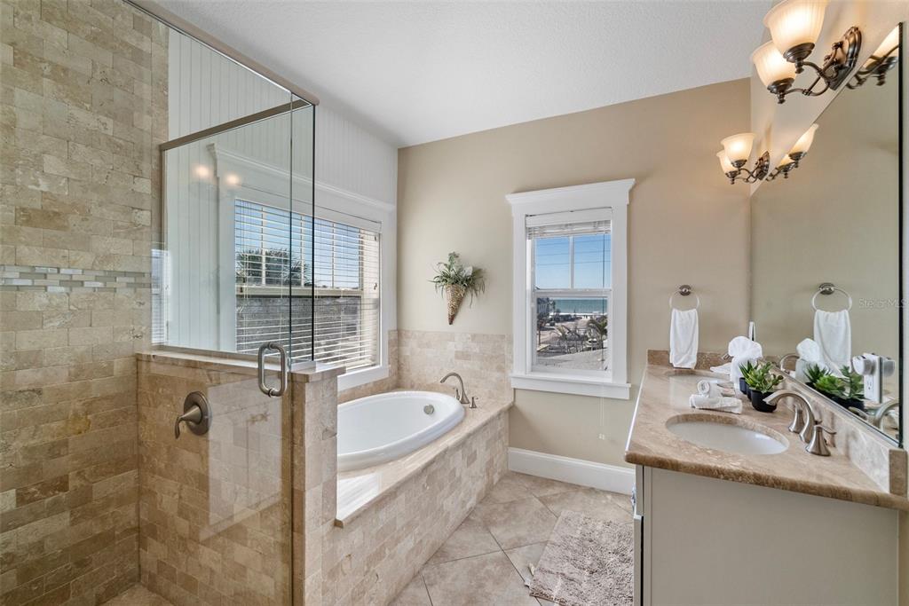 204 66th Street Holmes Beach, FL 34217 - Photo 33 of 53 a bath room with a granite countertop sink a toilet and bathtub