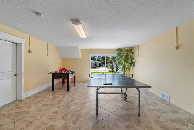 a living room with furniture a rug and a table