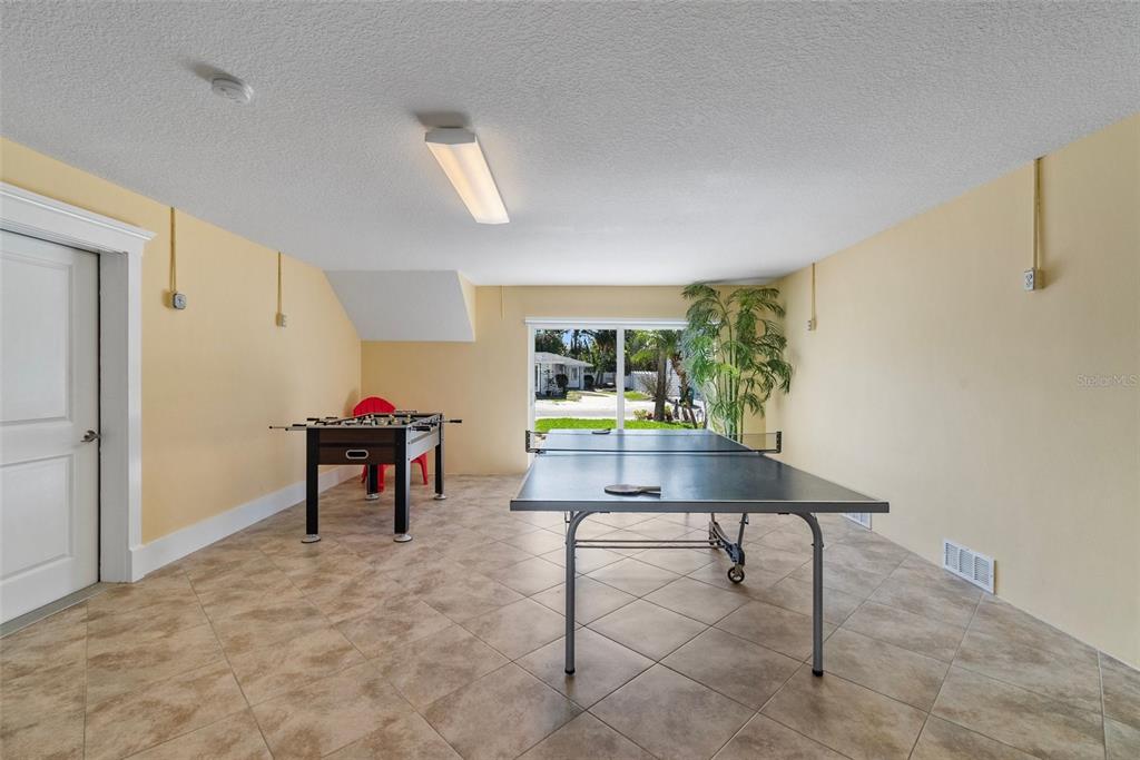 204 66th Street Holmes Beach, FL 34217 - Photo 41 of 53 a workspace room with furniture and a potted plant