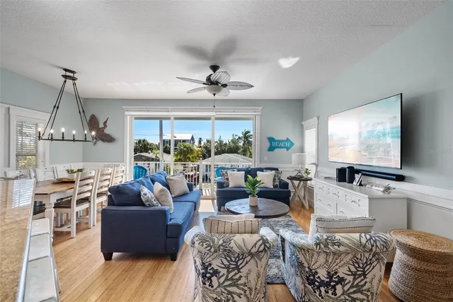 a living room with furniture a large window and a flat screen tv