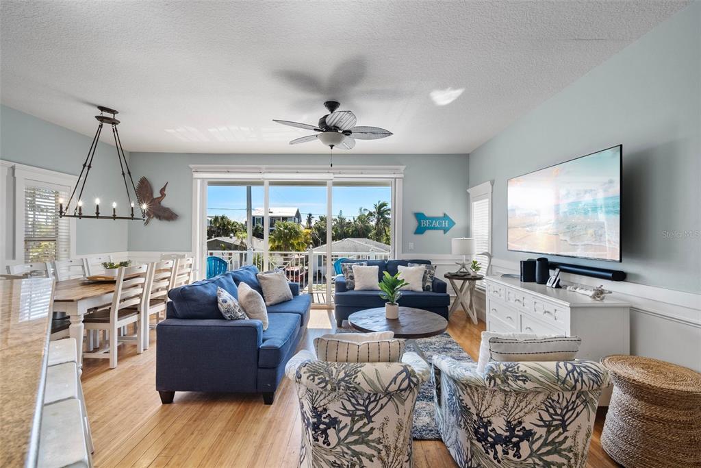 204 66th Street Holmes Beach, FL 34217 - Photo 7 of 53 a living room with furniture a large window and a flat screen tv