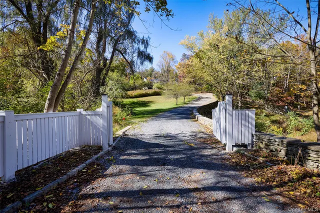 front view of a house with a tree in the background