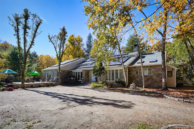 a view of a backyard with swimming pool