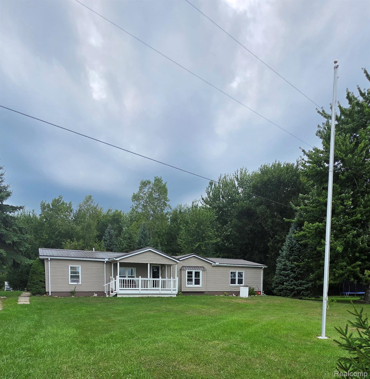 2611 Miller Road Allenton, MI 48002 - Photo 1 of 41 Single-story residence featuring light brown siding and a covered front porch with white railing