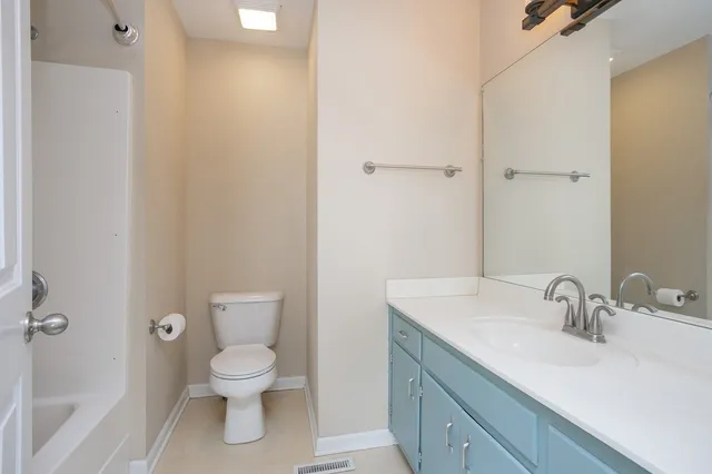 a bathroom with a sink toilet and vanity