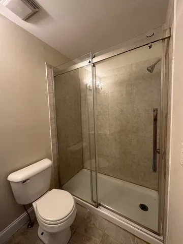 a bathroom with a shower and a toilet