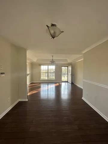 a view of a room with window and wooden floor