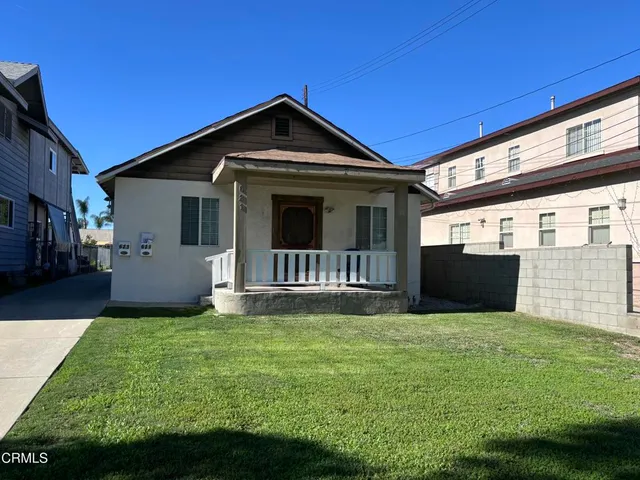 a front view of a house with yard and green space