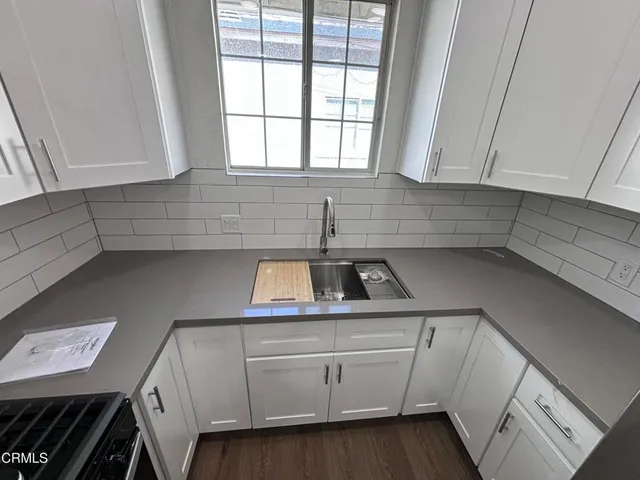 a kitchen with a sink and cabinets