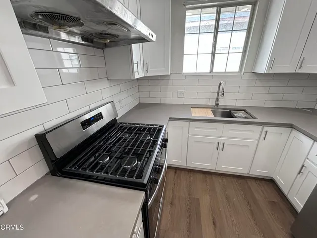 a stove top oven sitting inside of a kitchen