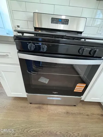 a stove top oven sitting inside of a kitchen