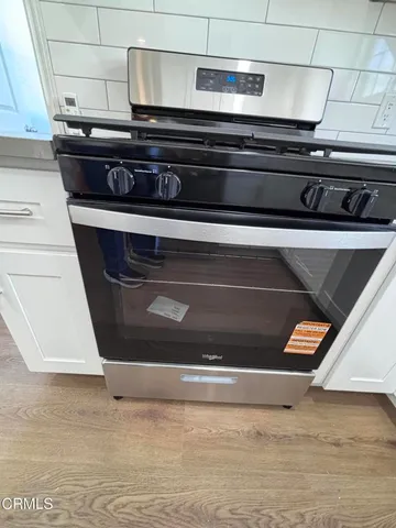 a stove top oven sitting inside of a kitchen