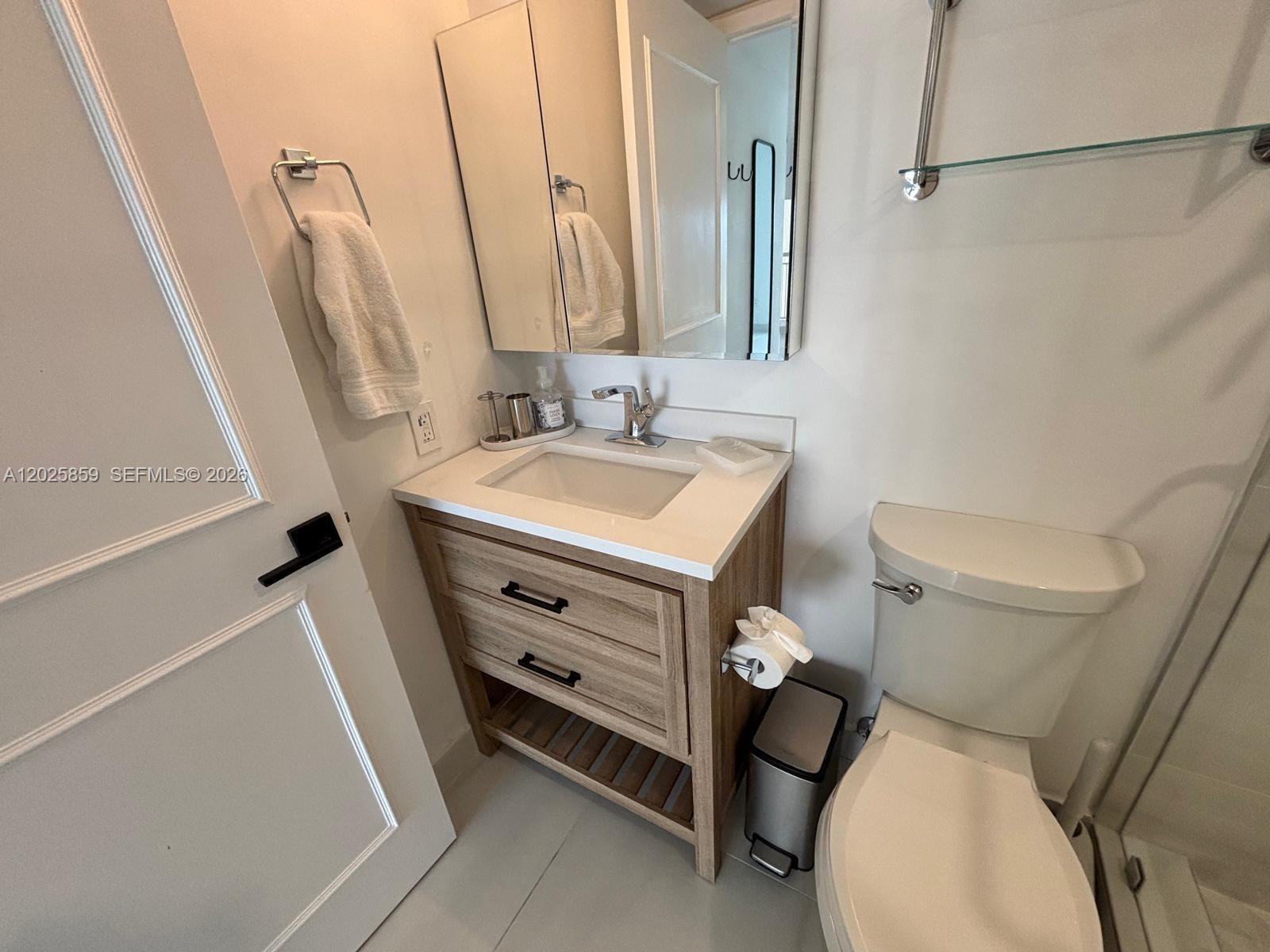 540 Brickell Key Drive, Unit 1024 Miami, FL 33131 - Photo 25 of 28 a bathroom with a sink a toilet and mirror