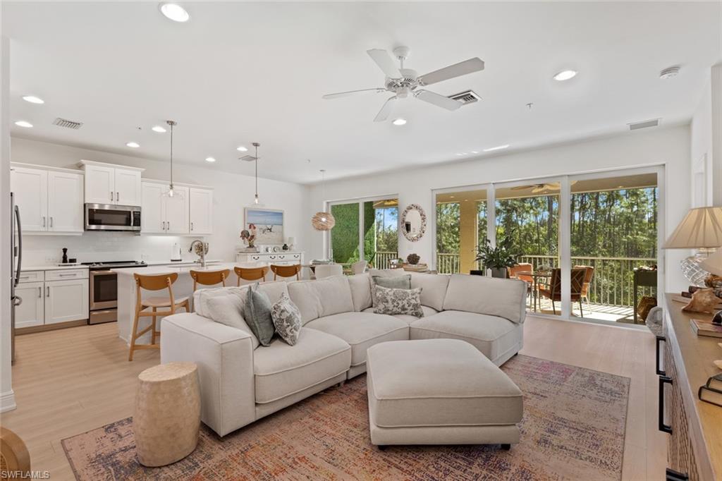 6973 Avalon Circle, Unit 1406 Naples, FL 34112 - Photo 9 of 36 Living area featuring light wood-type flooring, a ceiling fan, and recessed lighting