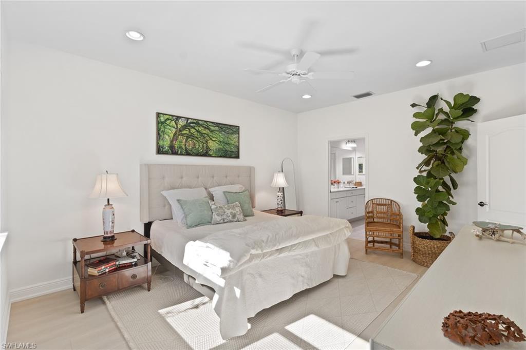 6973 Avalon Circle, Unit 1406 Naples, FL 34112 - Photo 11 of 36 Bedroom with a ceiling fan, ensuite bath, recessed lighting, and light wood-style floors