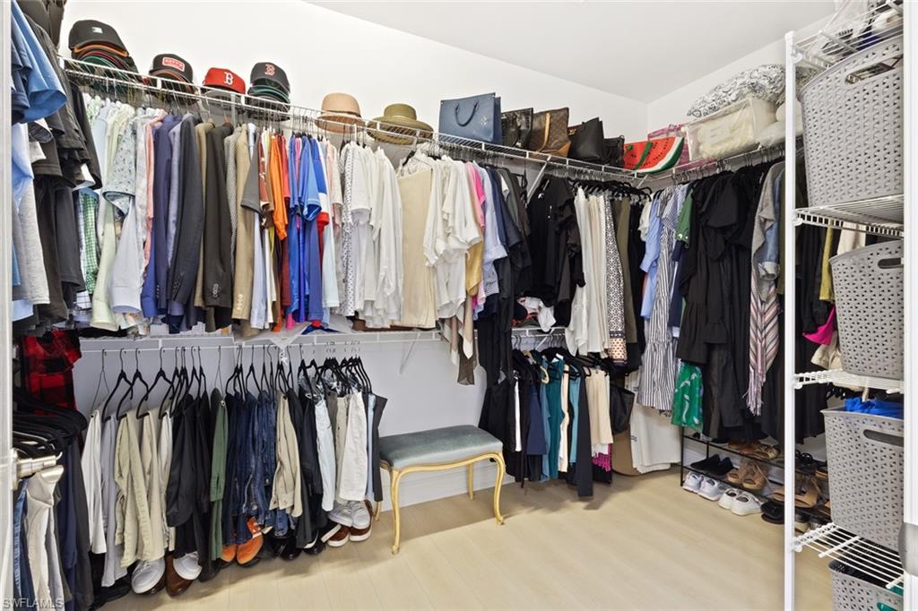 6973 Avalon Circle, Unit 1406 Naples, FL 34112 - Photo 16 of 36 Spacious closet featuring wood finished floors