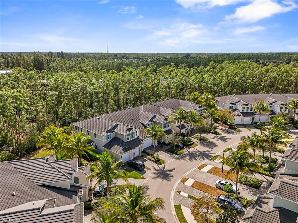 6973 Avalon Circle, Unit 1406 Naples, FL 34112 - Photo 29 of 36 Aerial view of a heavily wooded area