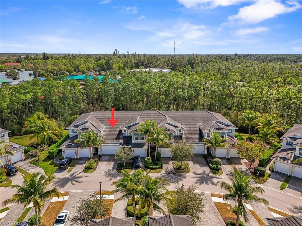 6973 Avalon Circle, Unit 1406 Naples, FL 34112 - Photo 30 of 36 Aerial overview of property's location featuring a heavily wooded area