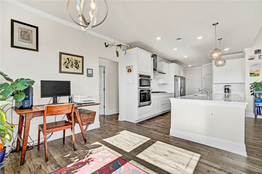 142 Juniper Hill Drive Easley, SC 29642 - Photo 13 of 47 An inviting kitchen with modern appliances and rich hardwood flooring, perfect for culinary endeavors.