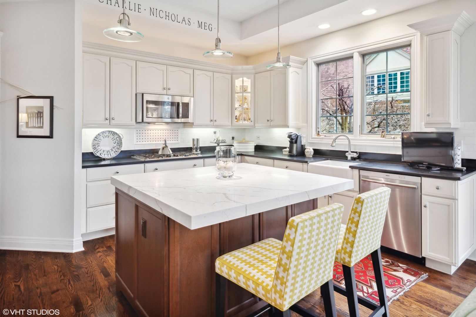 432 Fox Meadow Drive Northfield, IL 60093 - Photo 6 of 33 a kitchen with a stove a sink a dining table and chairs