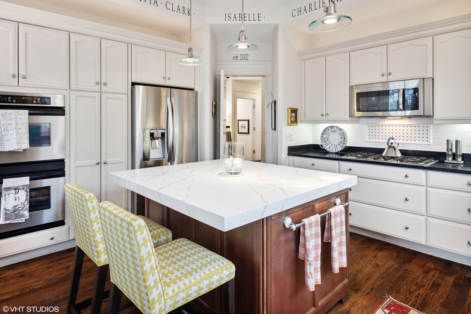 432 Fox Meadow Drive Northfield, IL 60093 - Photo 7 of 33 a kitchen with a table chairs refrigerator and cabinets