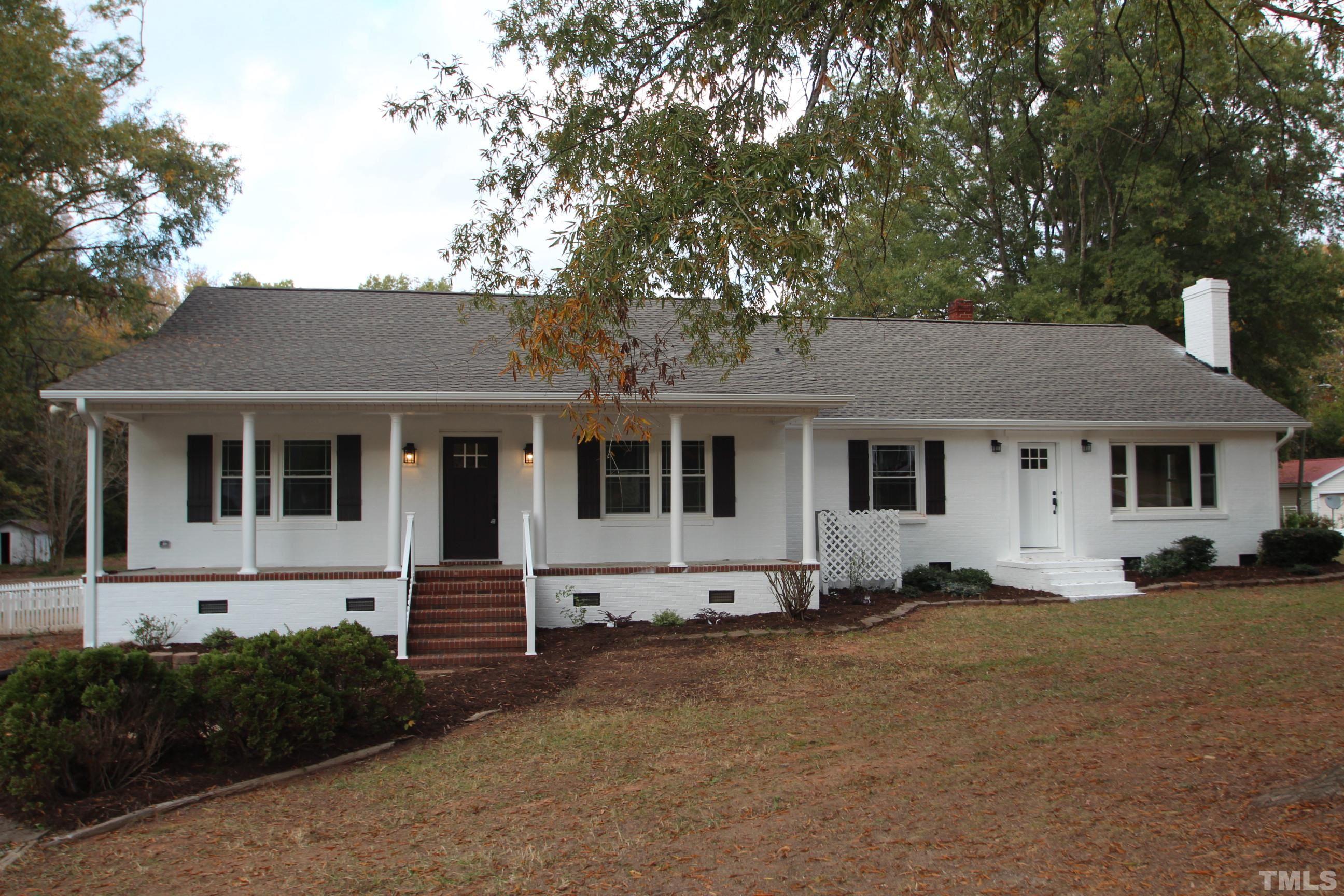 895 Oxford Road Roxboro, NC 27574 - Photo 1 of 23 a front view of a house with a yard