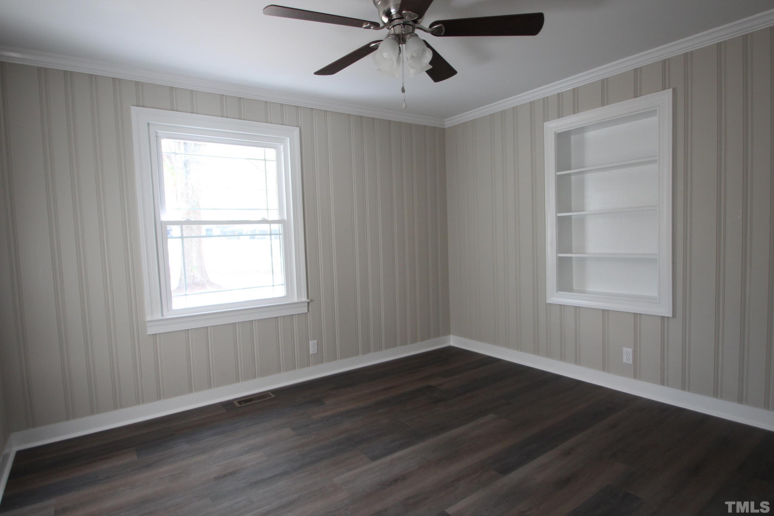 895 Oxford Road Roxboro, NC 27574 - Photo 12 of 23 a view of an empty room with wooden floor and a window