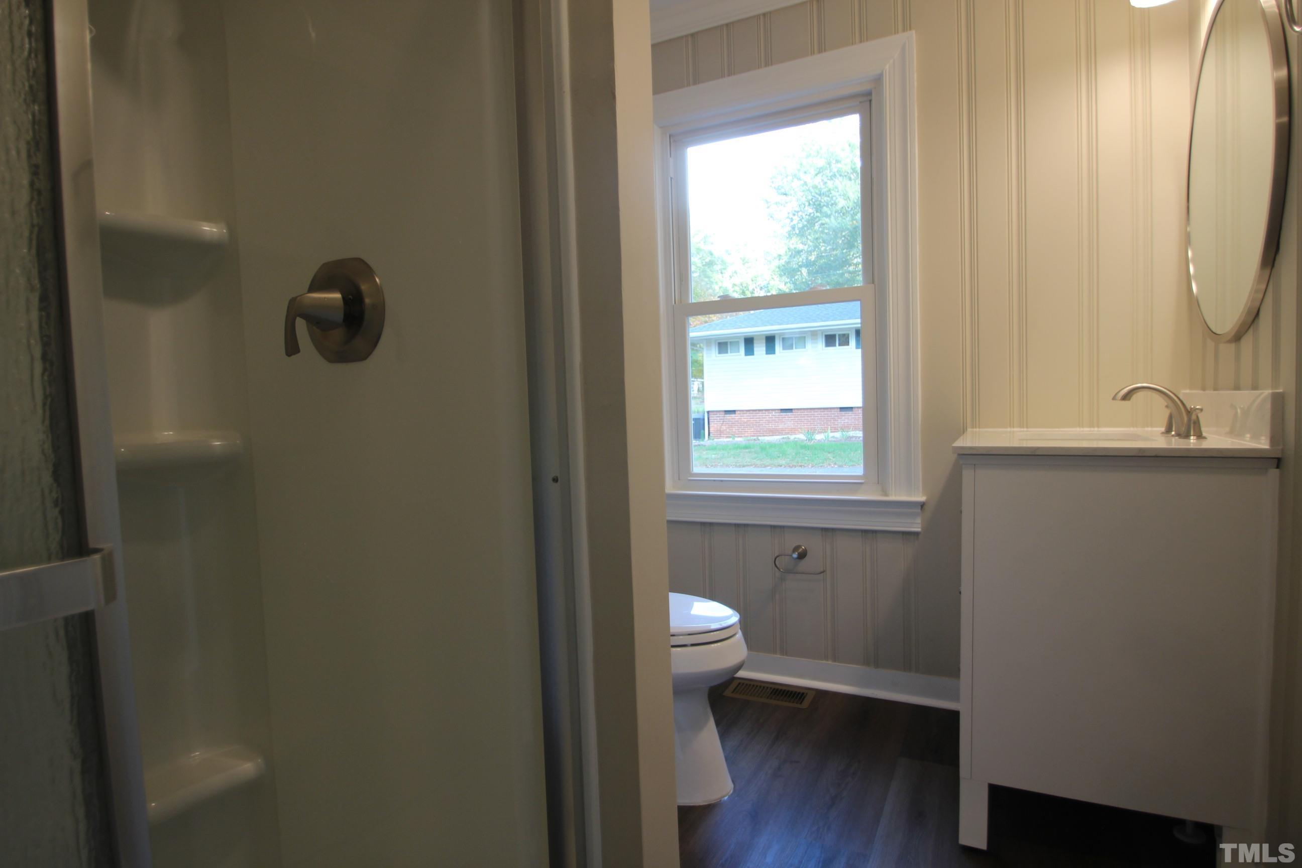 895 Oxford Road Roxboro, NC 27574 - Photo 14 of 23 a bathroom with a sink a toilet a window and shower