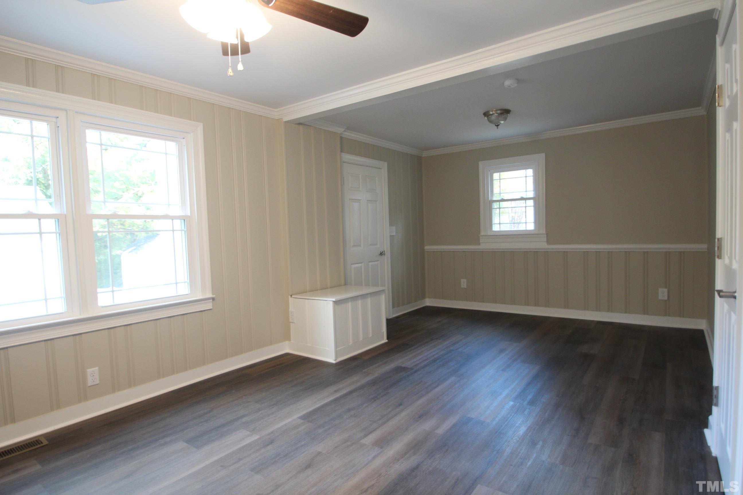 895 Oxford Road Roxboro, NC 27574 - Photo 15 of 23 a view of an empty room with wooden floor and a window