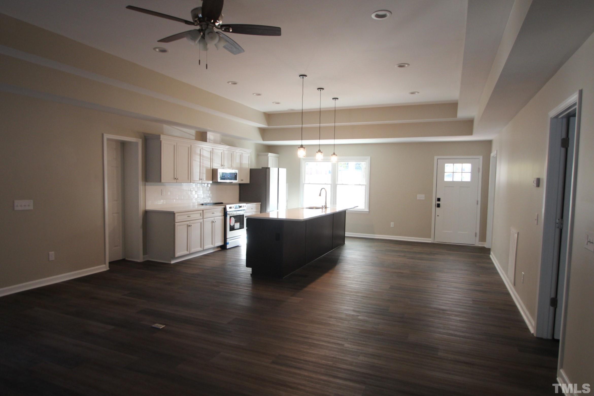 895 Oxford Road Roxboro, NC 27574 - Photo 17 of 23 a living room with stainless steel appliances kitchen island wooden floors and view living room