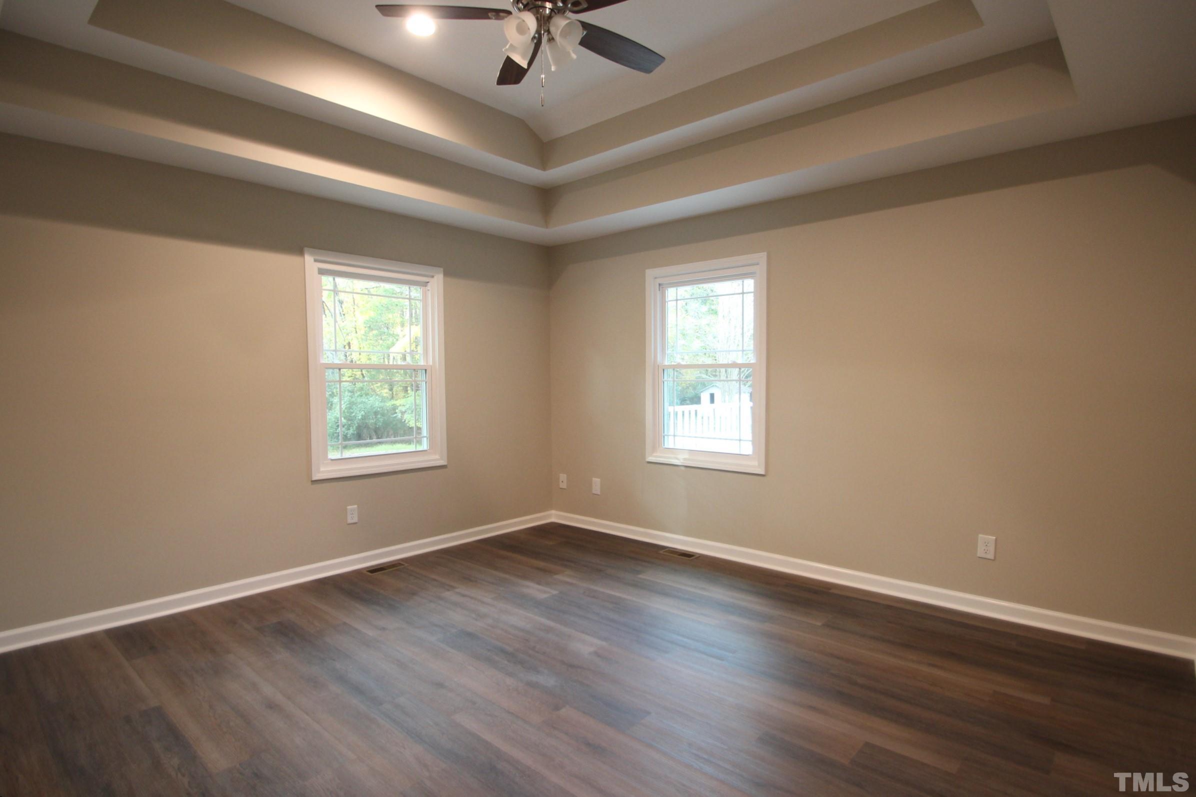 895 Oxford Road Roxboro, NC 27574 - Photo 9 of 23 a view of an empty room with wooden floor and a window