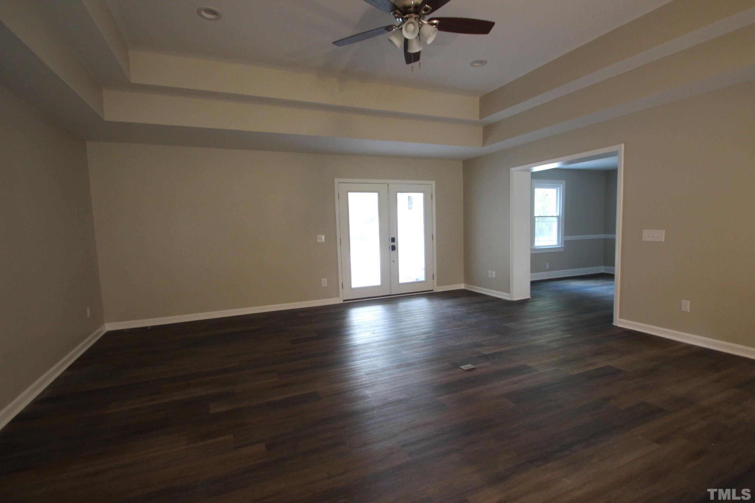 895 Oxford Road Roxboro, NC 27574 - Photo 10 of 23 a view of an empty room with a window and wooden floor