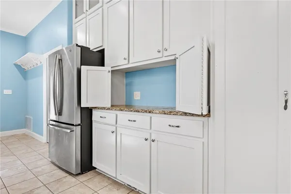 a kitchen with stainless steel appliances white cabinets and a refrigerator