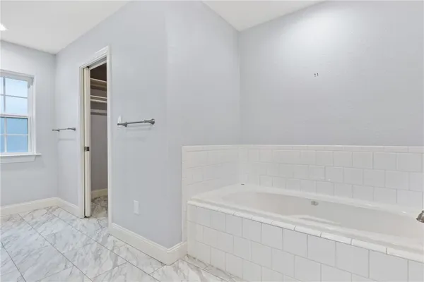 a bathroom with bathtub and shower