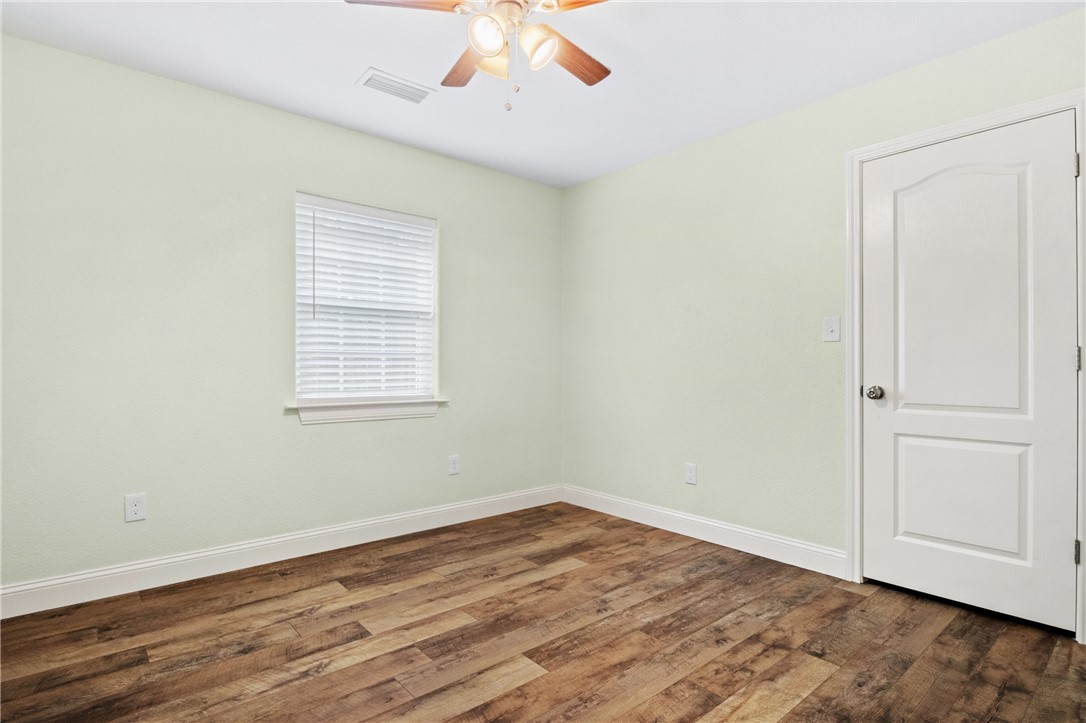 275 Woodruff Road Waco, TX 76705 - Photo 31 of 42 an empty room with wooden floor cabinet and windows