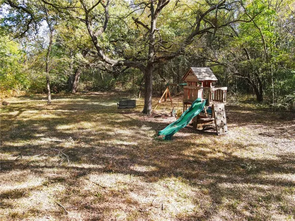 a view of outdoor space with playground and green space