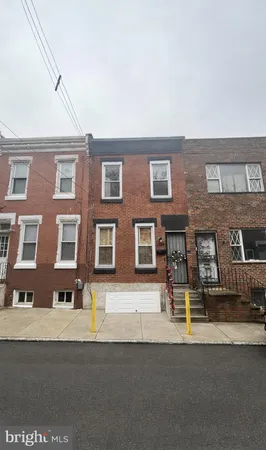 a front view of a building with parking space